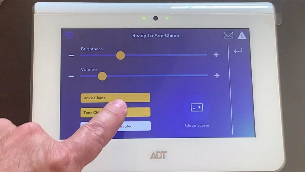 man's pointer finger pressing ADT's voice chime setting
