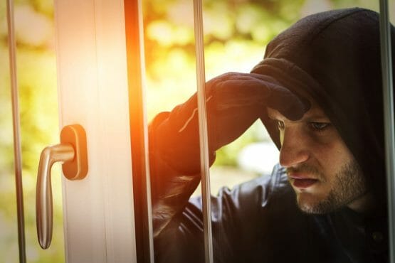 Burglar breaking in a house Burglar breaking in a house