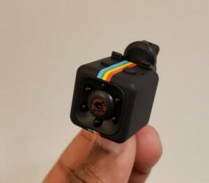 a hand holding a camera mini