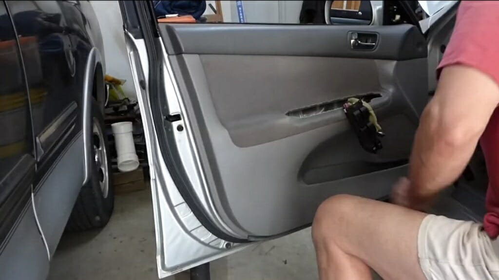 man connecting the car door panel