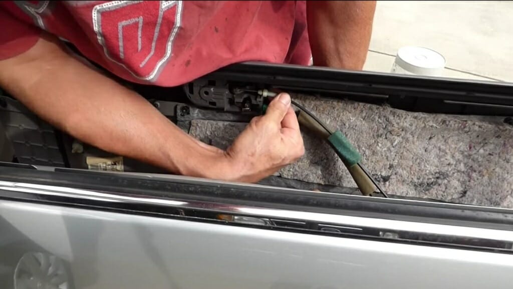 man disconnecting wire from door lock to the door handle