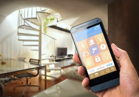 Man with smart home security app Man with smart home security app