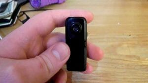 a hand holding a mini camera