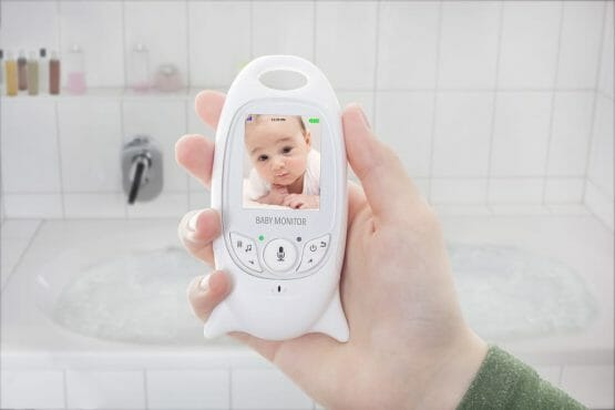 Mother checking baby through baby monitor when taking a bath