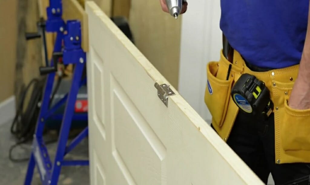 screwing the hinges on the door