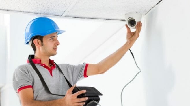 man holding the security camera