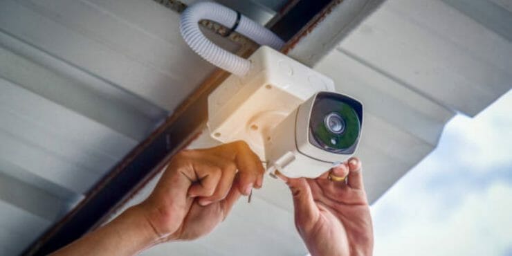 man installing security camera