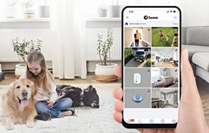 a hand holding a phone with swann app installed
