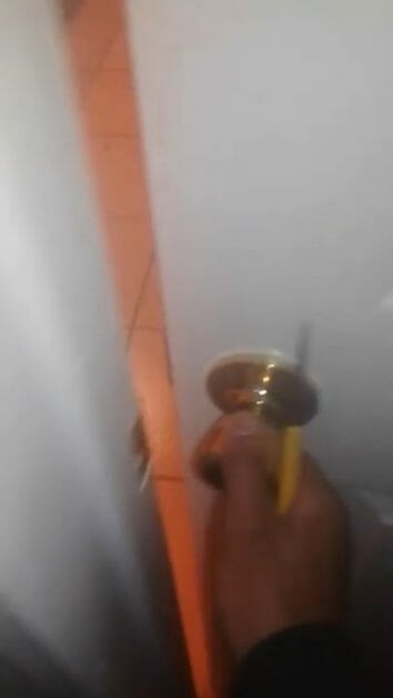 swiveling the screwdriver and opening the doorknob