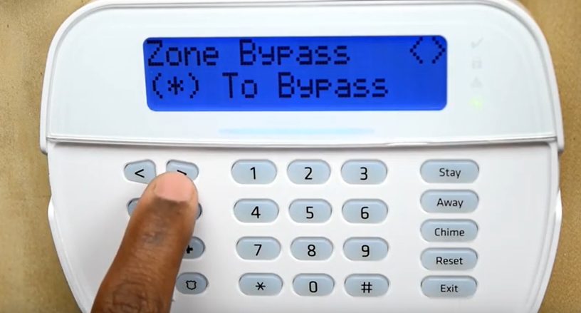 man setting up the zone to bypass on ADT device