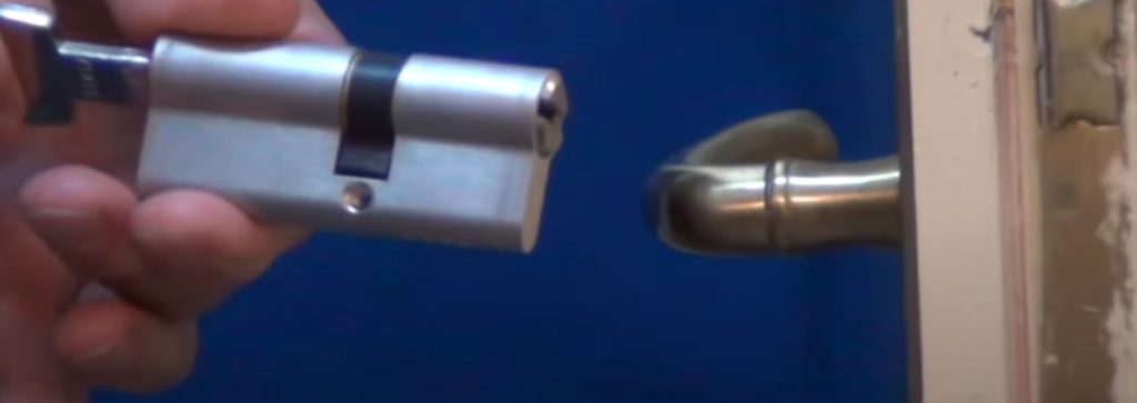 man installing lockset on the door